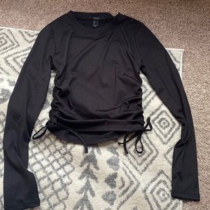 Cropped black top with draw string detail on sides.